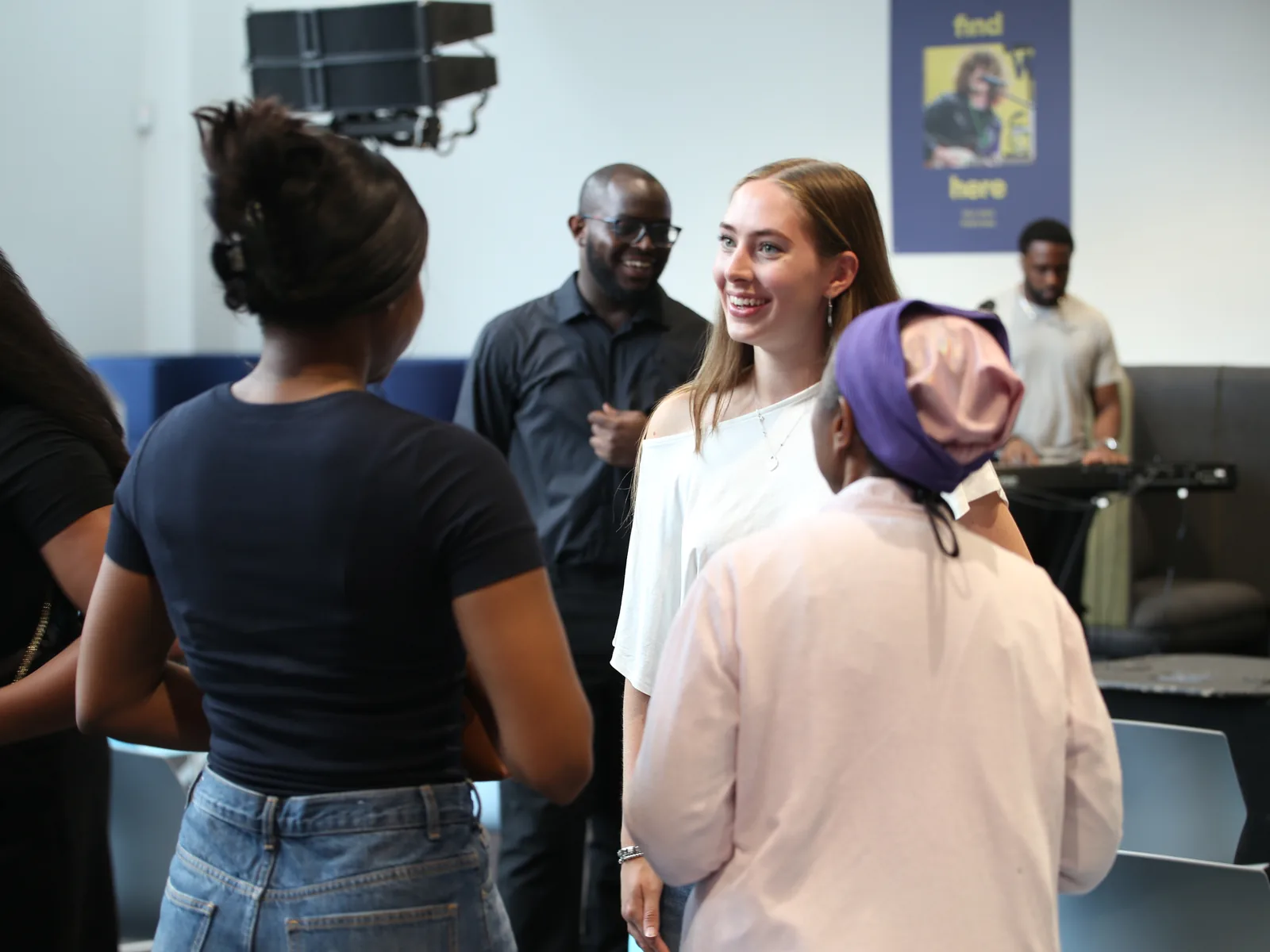 A group of people standing and chatting together after church at C3 Liverpool