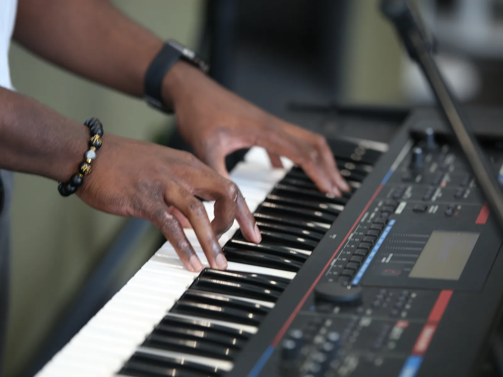 A musician playing keyboard during worship at a C3 Liverpool Sunday service