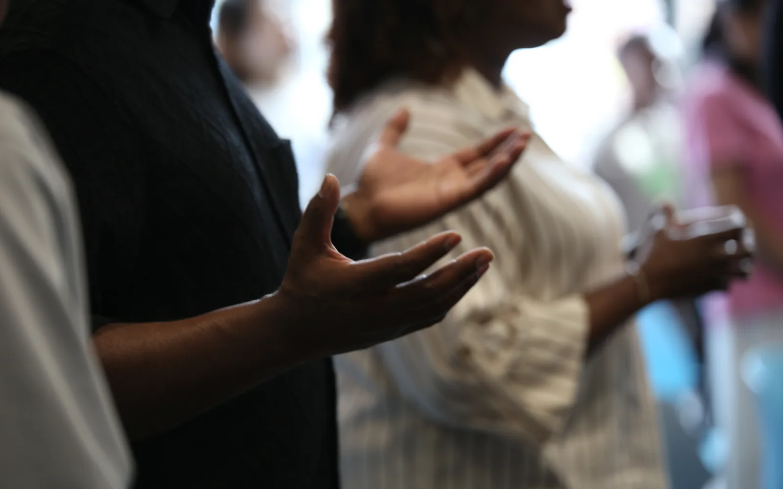 Hands raised in worship during a Sunday service at C3 Liverpool